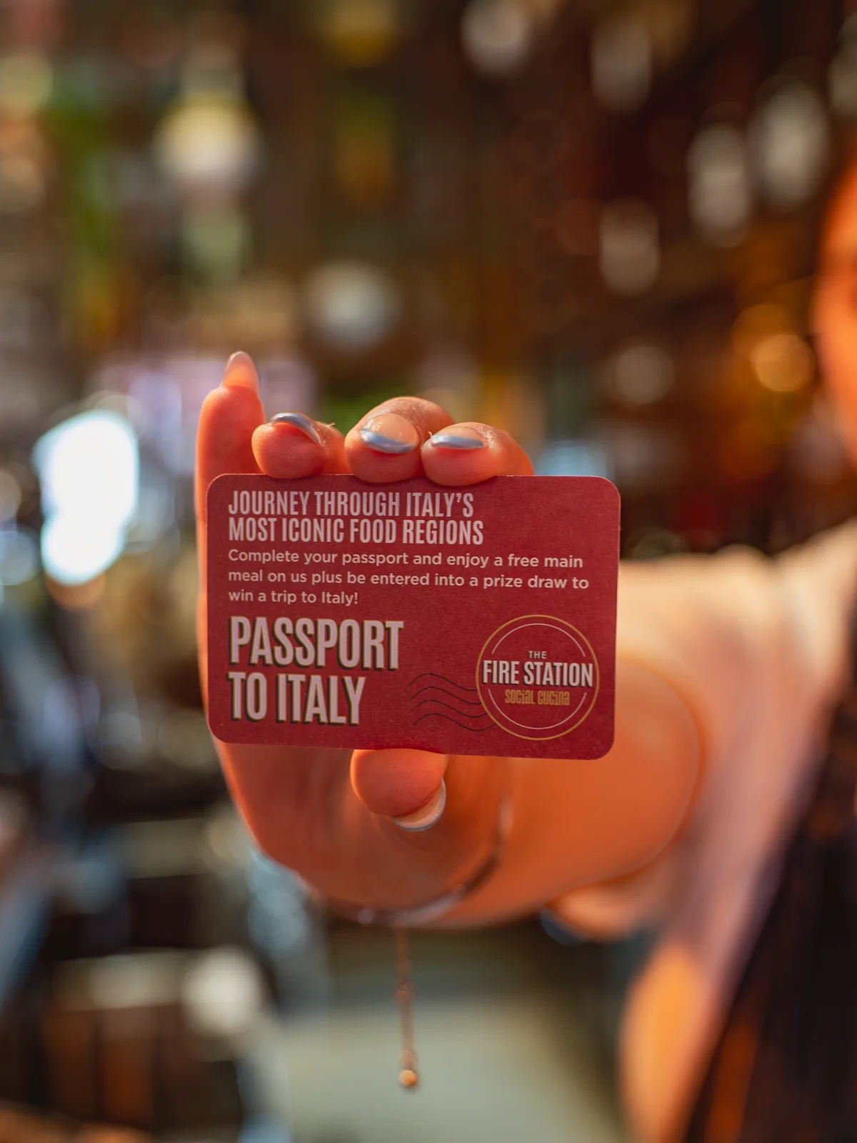 A Passport to Italy card held up in the restaurant