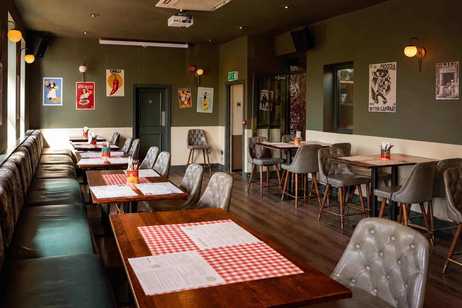 The upstairs room at The Fire Station Alderley Edge, tables set with gingham placemats